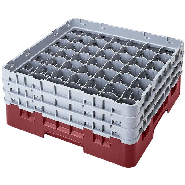 A red and white plastic Cambro glass rack with 49 compartments and 2 extenders.