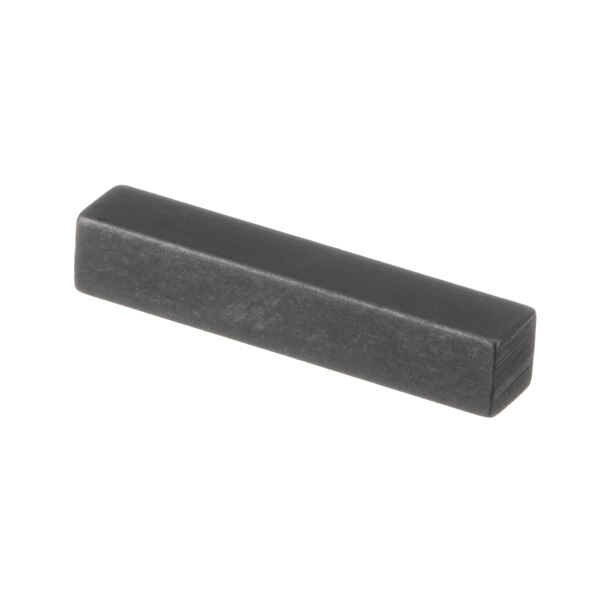 A close-up of a black rectangular Mannhart key.