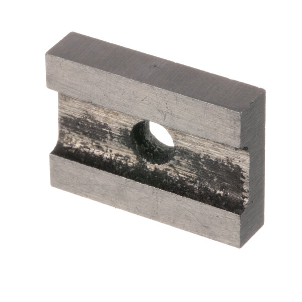 A small metal square with a hole in it.