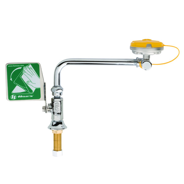 A yellow and green T&S eyewash faucet with a yellow handle.