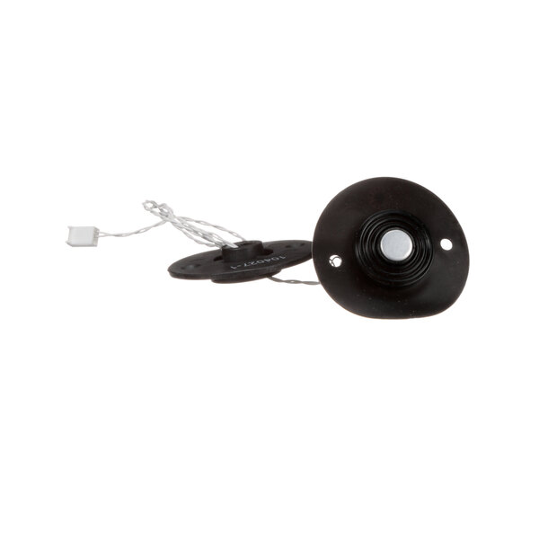 A black round object with a white cord and a wire.