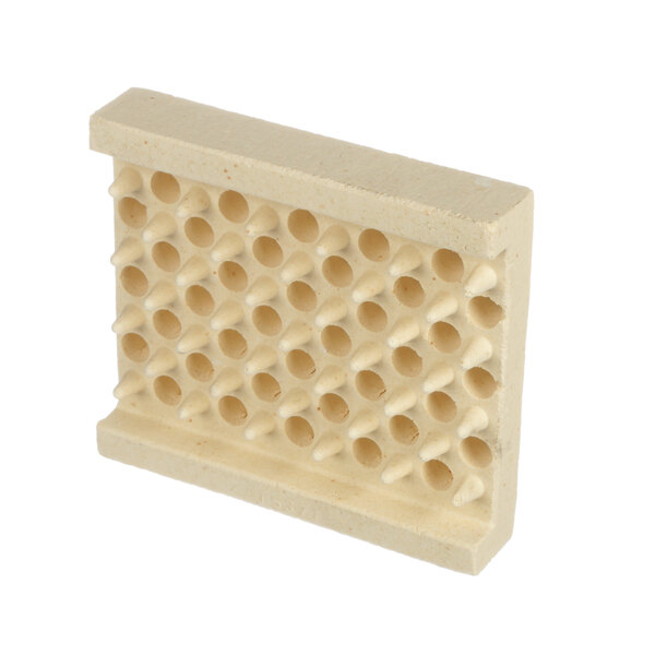 A white rectangular ceramic block with many holes.