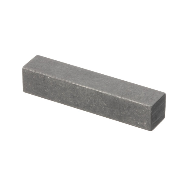 A rectangular metal object with a gray stone surface.