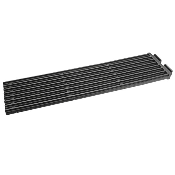 A black rectangular Magikitch'N cast iron grill grate with holes.