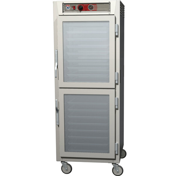 A stainless steel Metro C5 heated holding cabinet with clear Dutch doors.