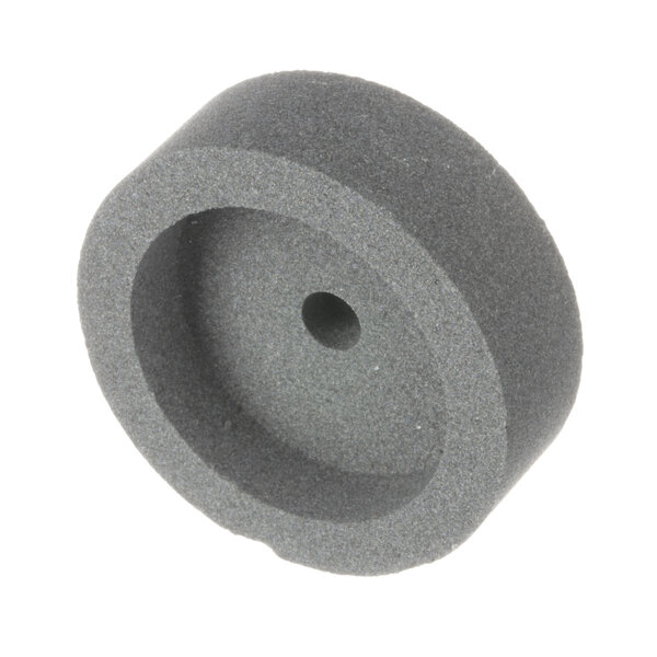 A grey round stone with a hole in it.