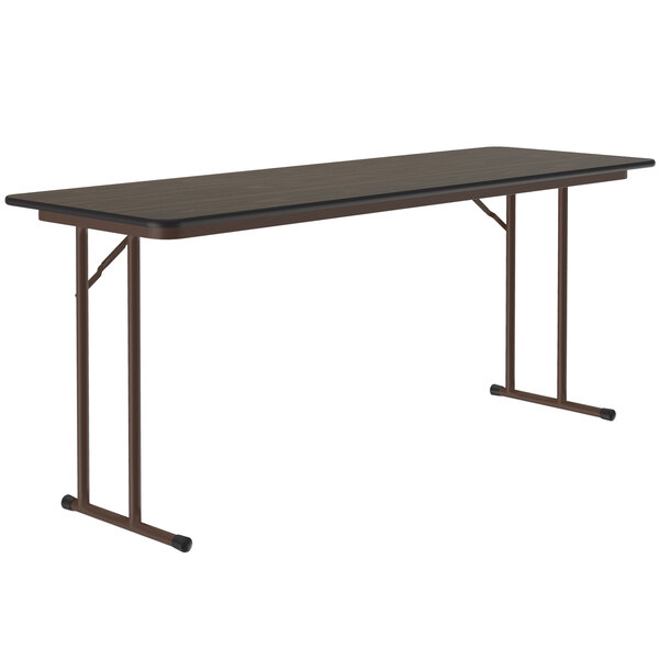A rectangular Correll seminar table with metal legs and a walnut top.