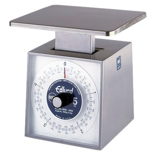 An Edlund stainless steel metric portion scale with a digital display on it.