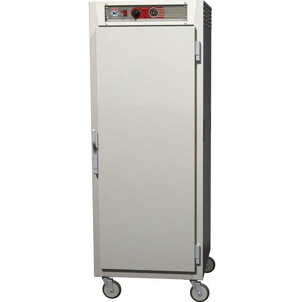 A stainless steel Metro C5 heated holding cabinet with wheels.