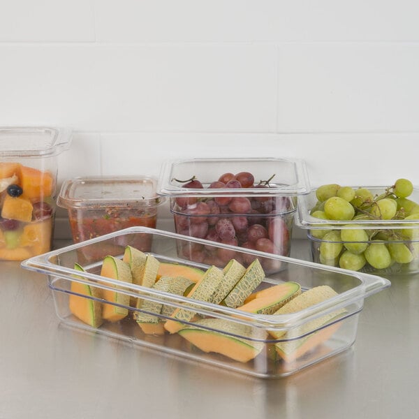 A Carlisle clear polycarbonate food pan with grapes in it.