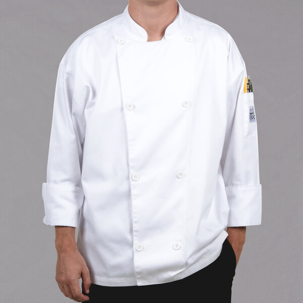 A man wearing a white Chef Revival chef coat with chef logo buttons.