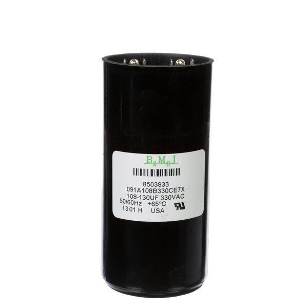 A black cylinder with a white label reading "Manitowoc Ice Start Capacitor"