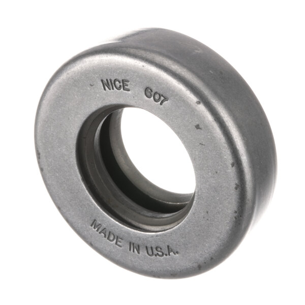 A round metal Groen bearing with a black rubber seal and the words "made in" in the center.