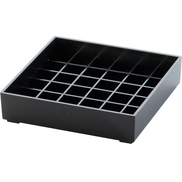 A black square drip tray with many square compartments.