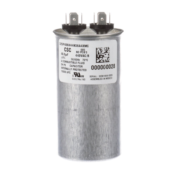 A round silver Manitowoc Ice run capacitor with a white label.