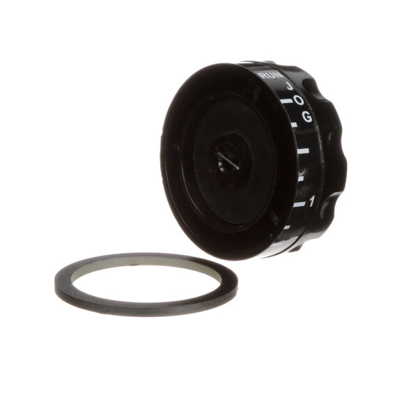 A black round knob with a round ring and white text.