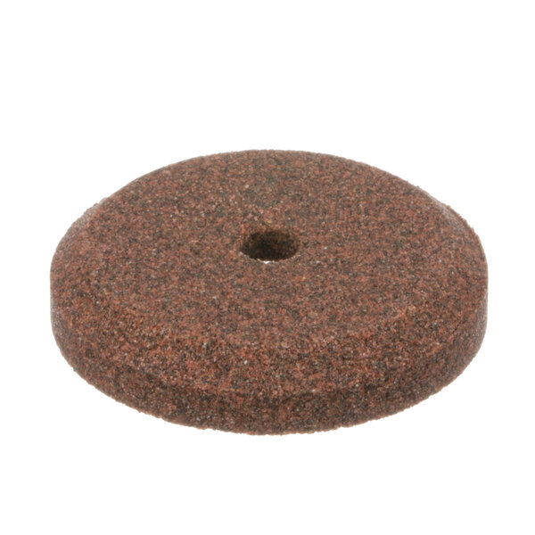 A brown circular Globe M091 sharpening stone with a hole in it.