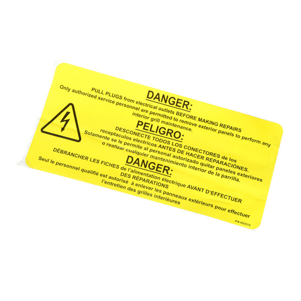 A yellow US Range label with black text reading "Danger" on a roll.