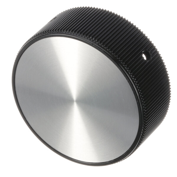 A silver and black circular NU-VU knob.