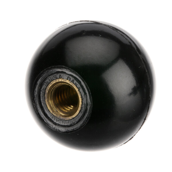 A black round knob with a gold screw in it.
