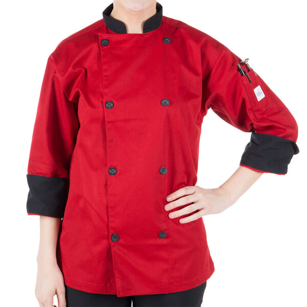 A person wearing a Mercer Culinary red chef coat with 3/4 length sleeves.
