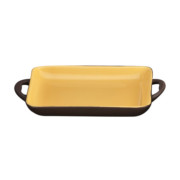 A rectangular brown stoneware baking dish with a handle.