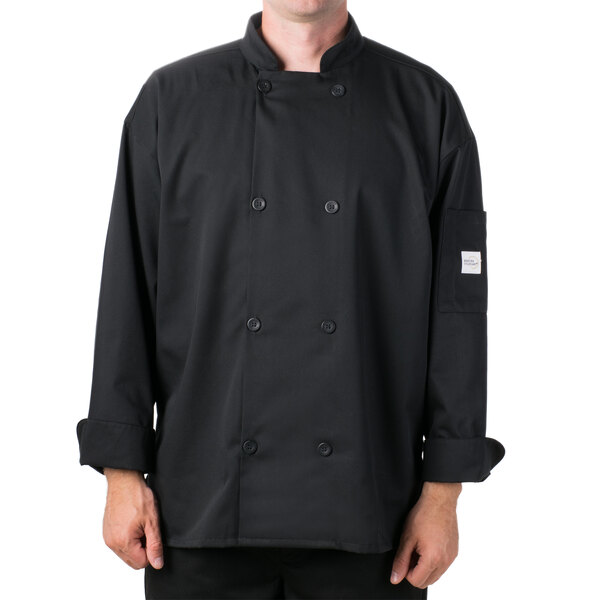 A man wearing a black Mercer Culinary long sleeve chef coat with a full mesh back.
