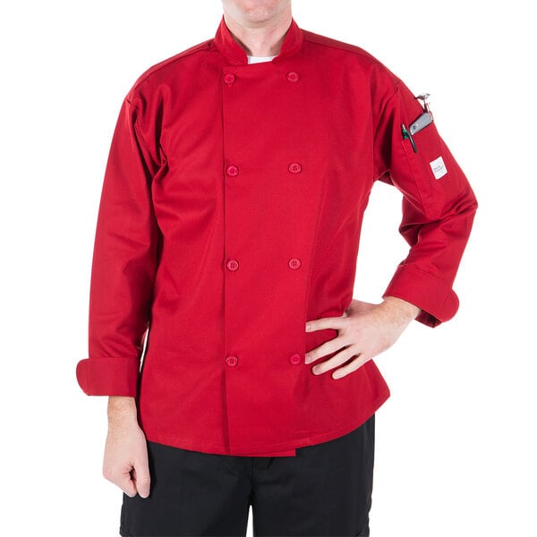 A man in a Mercer Culinary red chef coat standing in a professional kitchen.