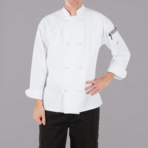 A man wearing a white Mercer Culinary long sleeve chef jacket with cloth knot buttons.