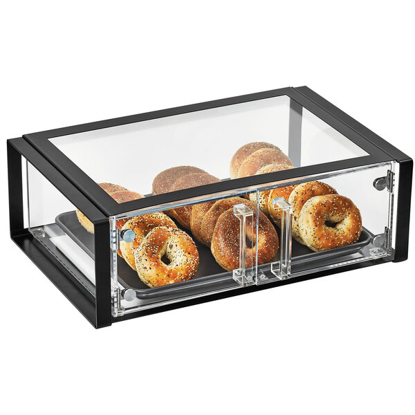 A Vollrath Cubic acrylic display case with bagels inside.