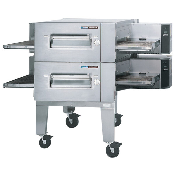 A Lincoln Impinger conveyor oven package with two low profile ovens on wheels.