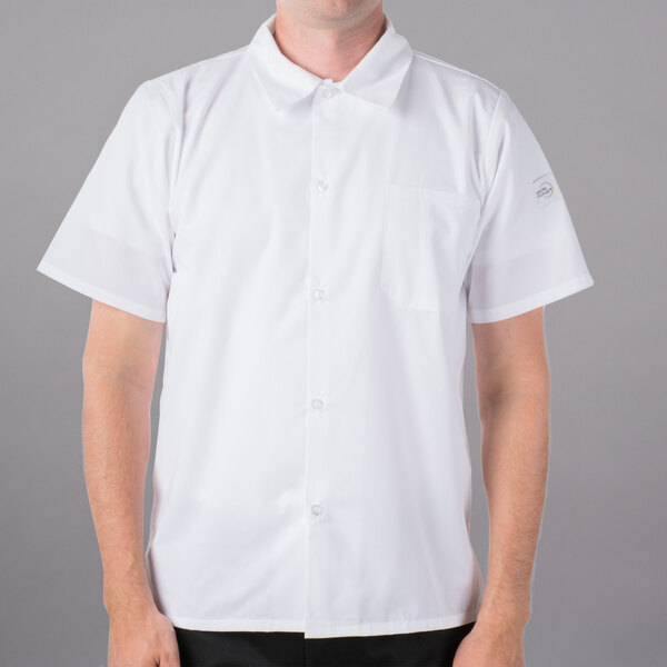A man wearing a Mercer Culinary Millennia white short sleeve cook shirt with full mesh back.