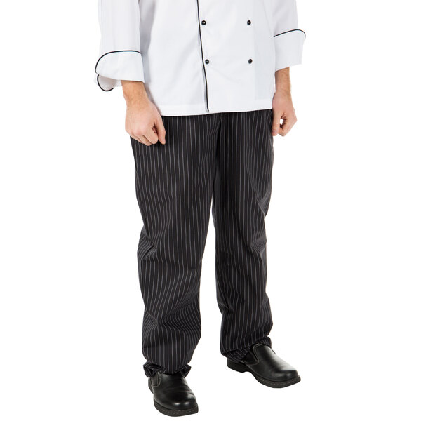 A person wearing Mercer Culinary Millennia pinstripe chef pants.