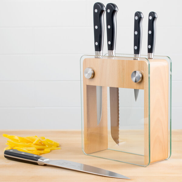 A Mercer Culinary Renaissance knife block with four knives and a knife sharpener on a counter.