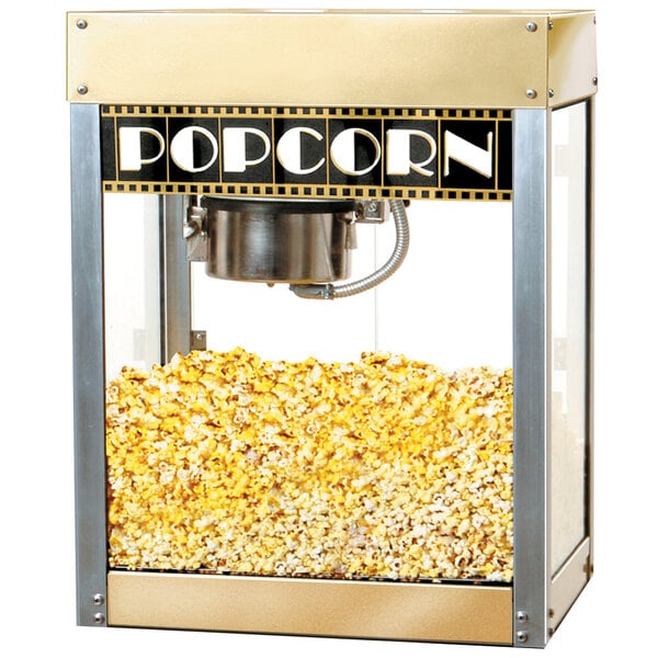 A Benchmark USA Premiere popcorn machine with gold and silver finishes filled with popcorn.