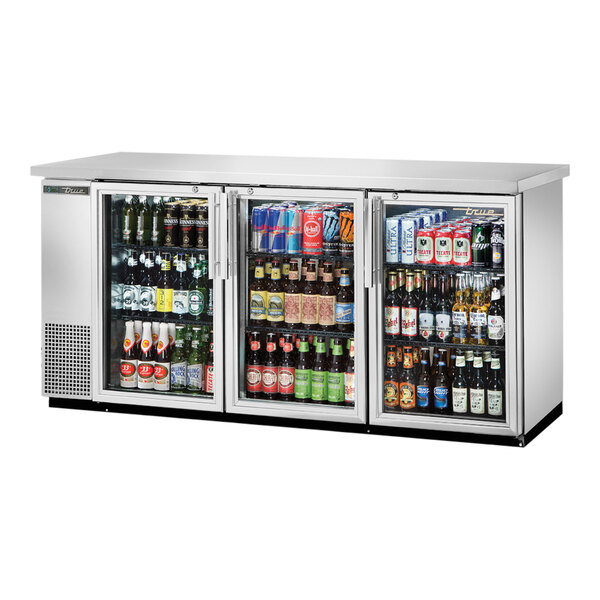 A True back bar refrigerator with glass swing doors full of drinks and beverages.
