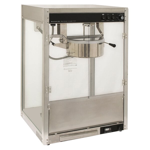 A Benchmark USA stainless steel popcorn machine with a glass door.