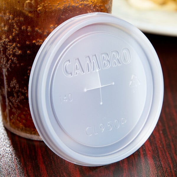 A plastic lid with a straw slot on a beverage container with text that reads "Cambro"