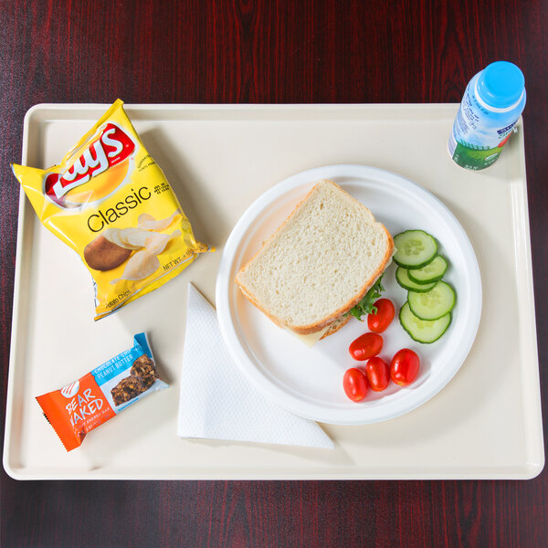 A Cambro dietary tray with a sandwich, vegetables, and a drink.