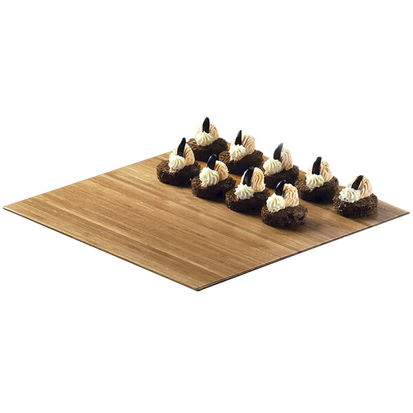 A Cal-Mil bamboo square tray with six small desserts on it.