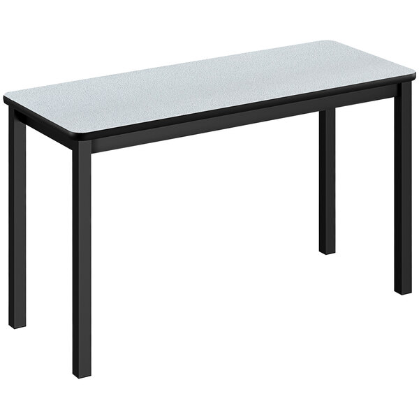 A white rectangular Correll lab table with black legs.