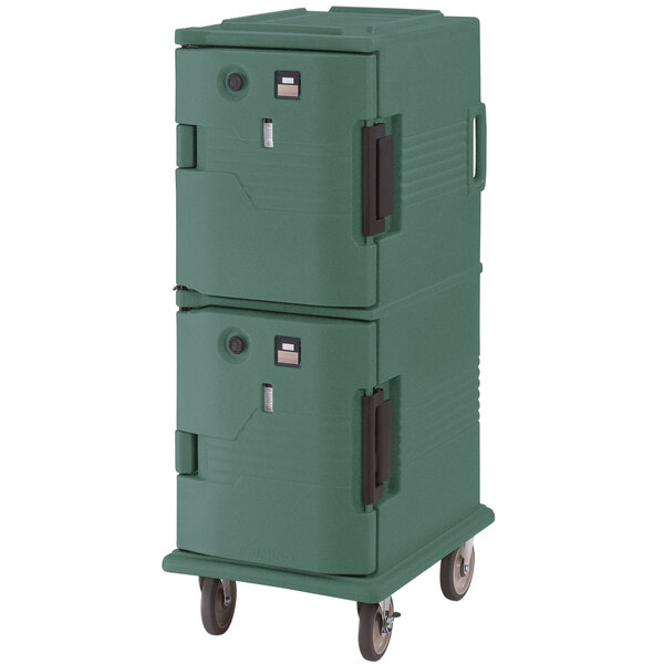 A Cambro Ultra Camcart in granite green holding hot food in a green plastic container on wheels.