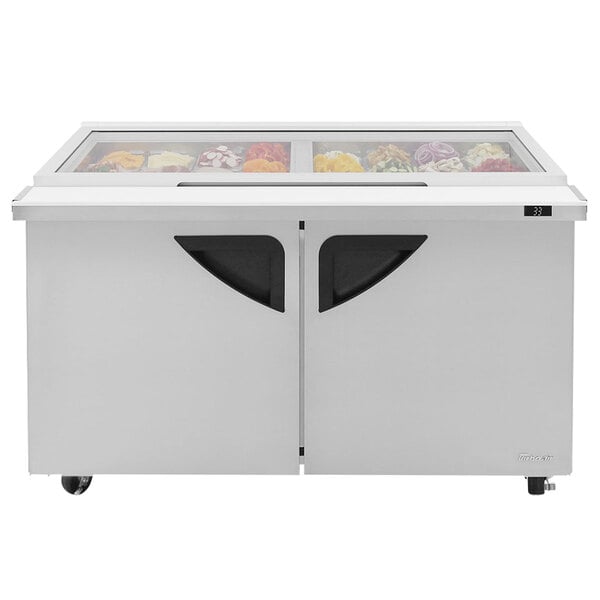 A Turbo Air refrigerated sandwich prep table with glass lids on the top.