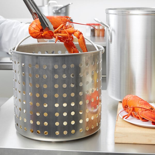 A Vollrath Wear-Ever fryer basket filled with lobster claws in a pot.