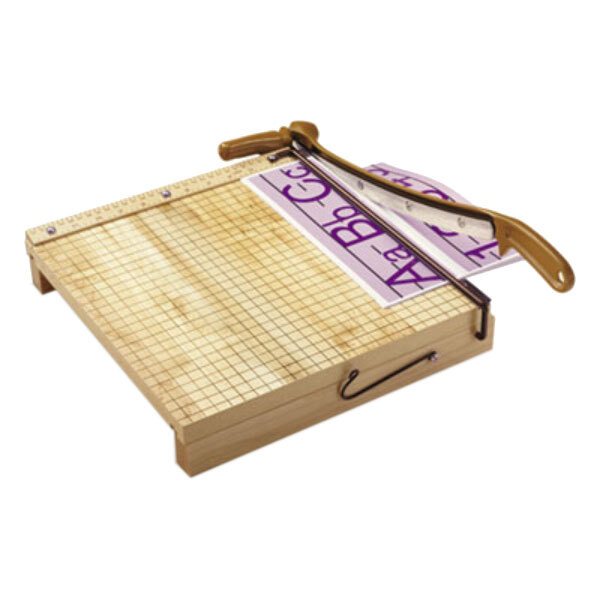 A Swingline Ingento paper cutter with a piece of paper on a wooden surface.