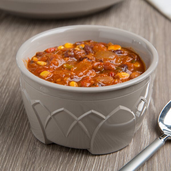 A bowl of chili with beans and corn in a Fenwick insulated bowl with a spoon.