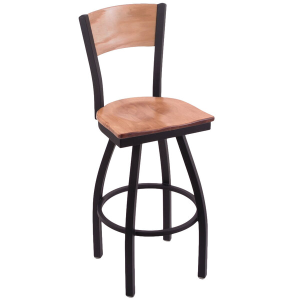 A black steel restaurant bar stool with a wooden back and seat with an NHL logo laser engraved on the back.
