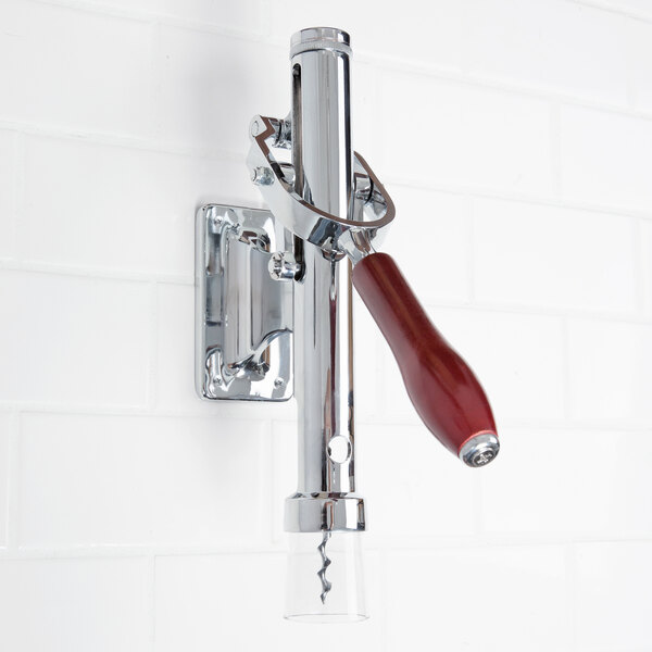 A Franmara chrome-plated wall mount wine bottle opener on a white wall.