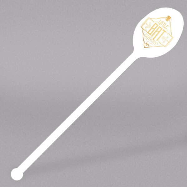 A white plastic WNA Comet mixed drink stirrer with a logo on it.