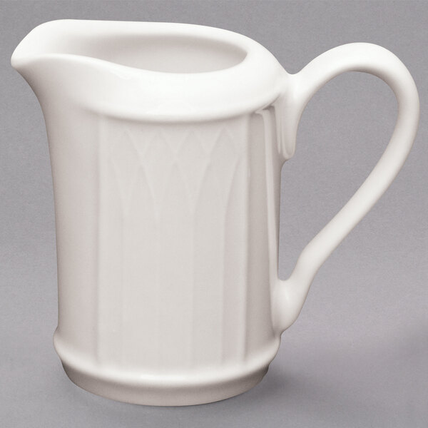 A Homer Laughlin ivory china creamer with a handle.
